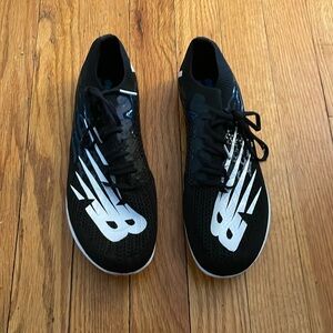 Men’s New Balance track shoes with metal spikes.